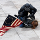 A police officer detains a pro-Trump protester as mobs storm the U.S. Capitol, during a rally to contest the certification of the 2020 U.S. presidential election results by the U.S. Congress, at the U.S. Capitol Building in Washington, U.S, January 6, 2021.